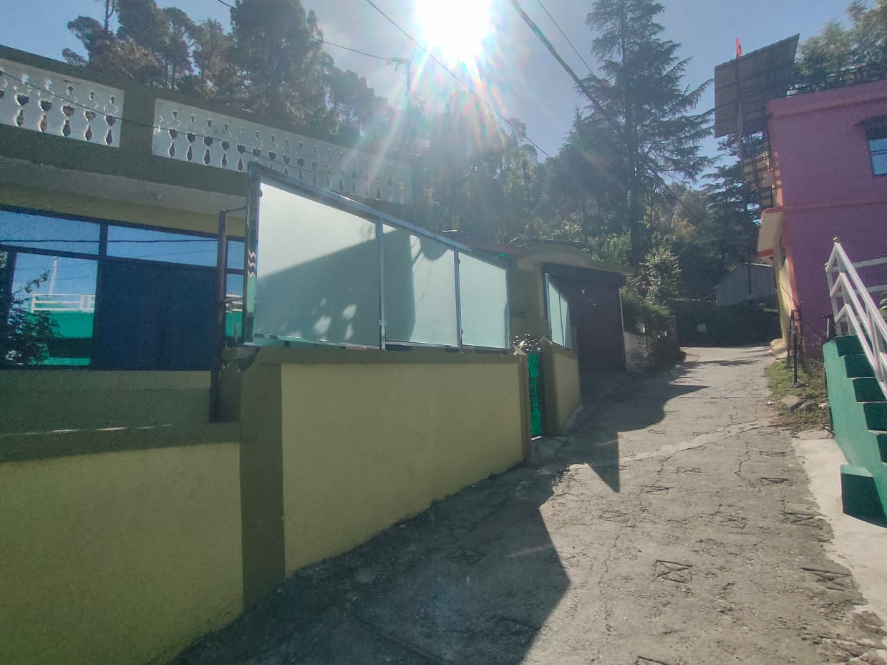Front of Malti Home Stay building with glass balcony railing
