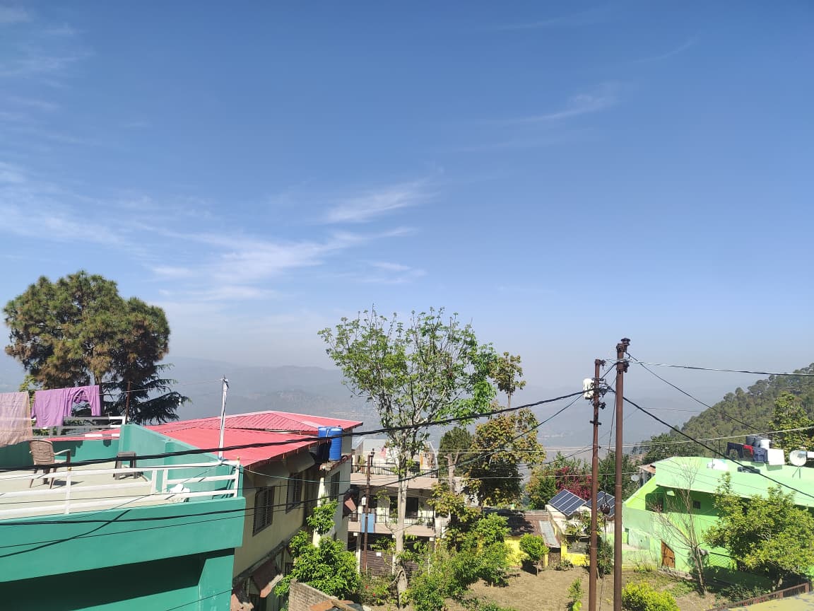 Panoramic view from Malti Home Stay showing Almora valley and hills
