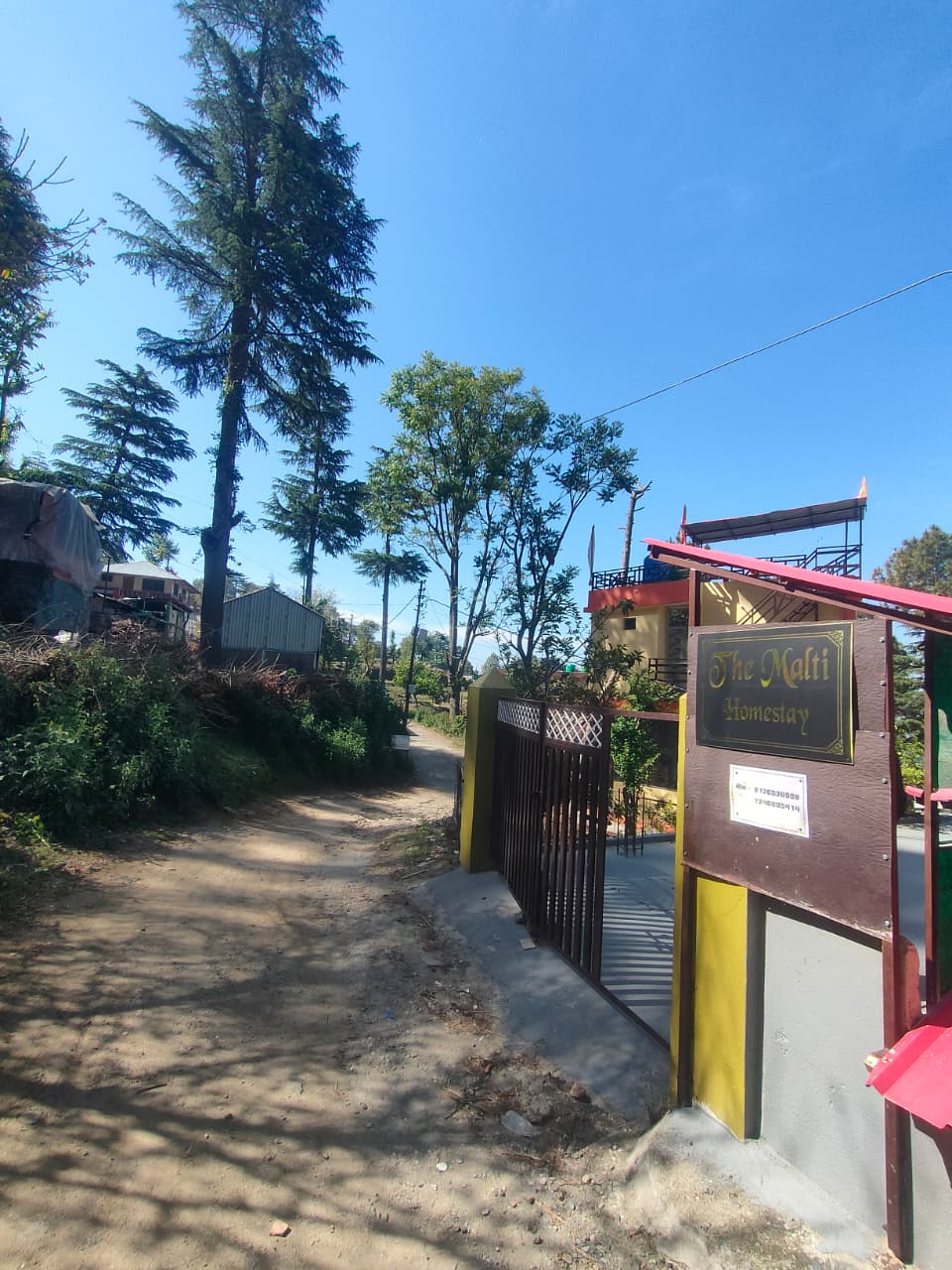 Entrance gate of Malti Home Stay with the property sign, Almora